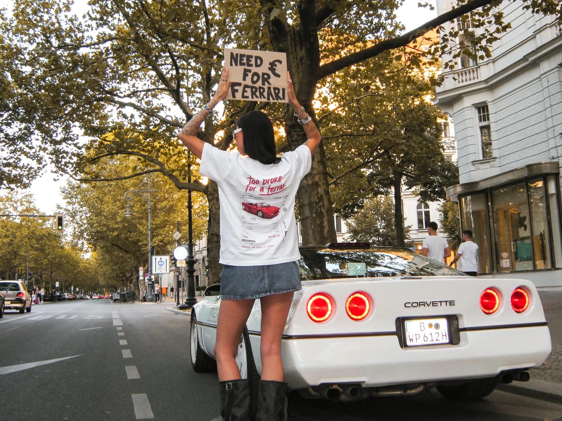 too broke for a ferrari tee next to a corvette